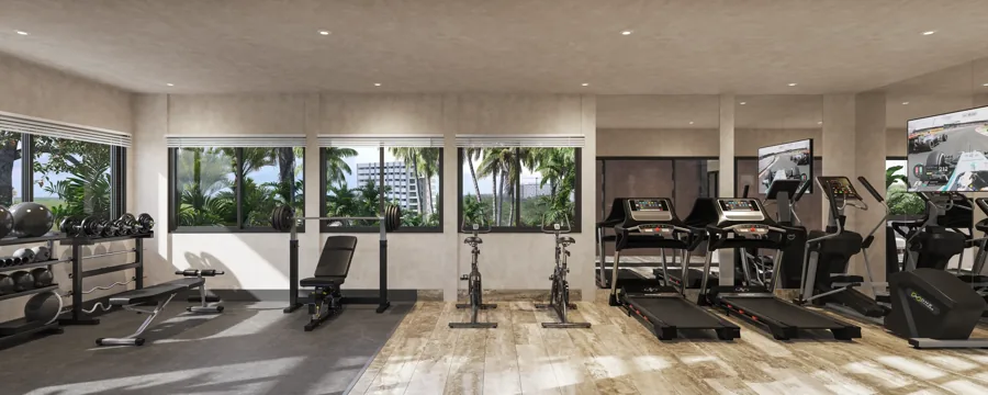 Gimnasio del proyecto con ventanales hacia la vegetación